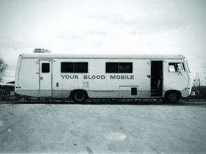 Vintage black and white photo of a bloodmobile