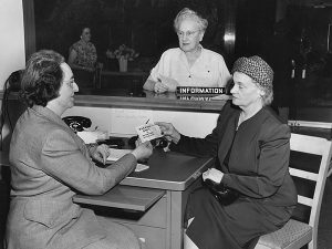 Vintage photograph of three women at a help desk at Bloodworks Northwest